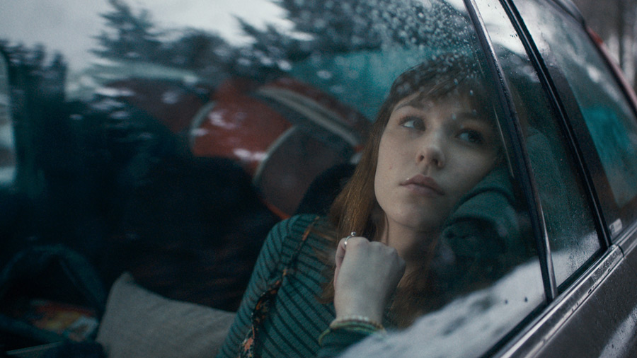 Film still: a girl in a car